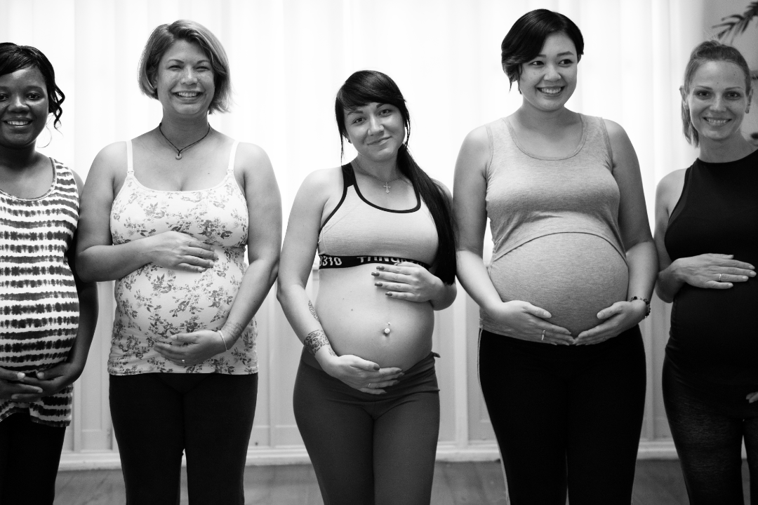 Group of diverse expecting people at a childbirth education workshop